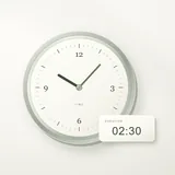 A silver clock beside cards showing a shift in time
